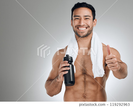 Fitness, portrait and thumbs up of man with water bottle in studio on gray background for health or hydration. Body, exercise and smile with happy sports person at gym for training motivation Fitness, portrait and thumbs up of man with water bottle in studio on gray background for health or hydration. Body, exercise and smile with happy sports person at gym for training motivation 119292963
