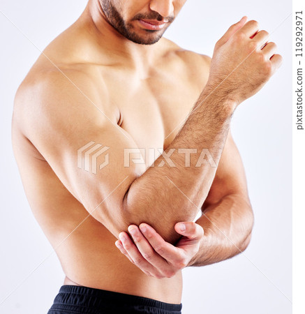Muscular man, elbow and bone with pain from accident, fall or injury on a white studio background. Closeup of male person or bodybuilder with sore arm, muscle or joint from tension or inflammation 119292971