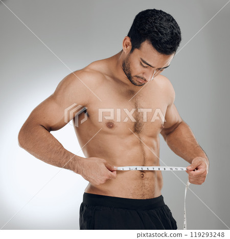 Man, studio and measuring tape for exercise, weight loss and wellness with health and fitness. Guy, workout and results for training, body and diet with muscle and topless athlete on grey background Man, studio and measuring tape for exercise, weight loss and wellness with health and fitness. Guy, workout and results for training, body and diet with muscle and topless athlete on grey background 119293248