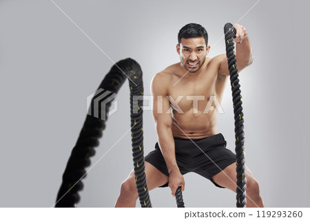 Battle ropes, man and portrait in studio for exercise, fitness and core workout on gray background. Asian male person, training and serious for intense, muscles and strength or endurance and power Battle ropes, man and portrait in studio for exercise, fitness and core workout on gray background. Asian male person, training and serious for intense, muscles and strength or endurance and power 119293260