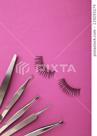 Set of false eyelashes extencions on pink background with tweezers. Minimalism. Verctical photo Set of false eyelashes extencions on pink background with tweezers. Minimalism. Verctical photo 119293274