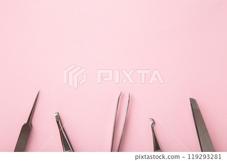 Beauty and fashion concept - tools for Eyelash Extension Procedure. Tweezers on pink background. Copyspace mockup 119293281