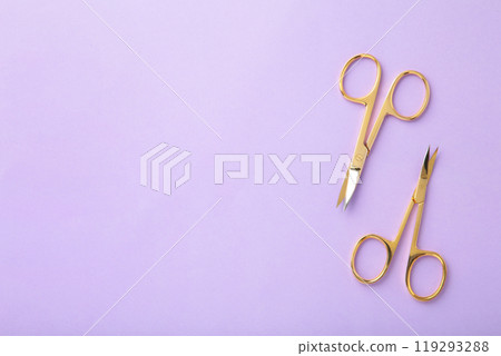Scissors for manicure woman nails on purple background with copy space 119293288