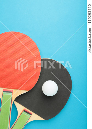 Ping pong rackets and ball on blue background 119293320