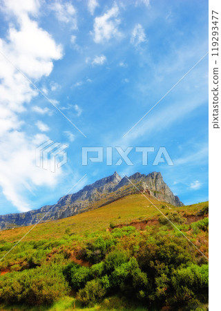 Blue sky, clouds and mountain at countryside for environment, sustainability and summer growth. Nature, beauty and hill with grass in daylight for eco friendly, green earth and sunshine in Japan 119293477