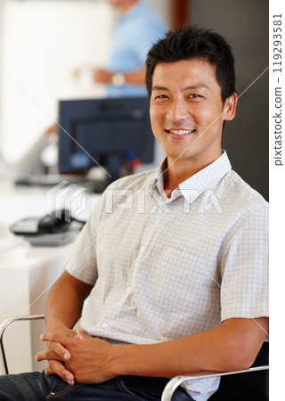 Portrait, man and happy in creative office, web designer sitting in chair in workplace. Smile, professional and Asian male person in business, confident and comfortable relaxing Japanese staff Portrait, man and happy in creative office, web designer sitting in chair in workplace. Smile, professional and Asian male person in business, confident and comfortable relaxing Japanese staff 119293581