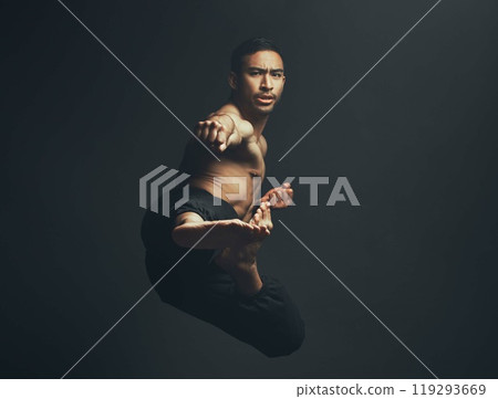 Martial arts, kick and man in portrait, training and fitness for wellbeing in studio backdrop for karate or capoeira. Male person, foot and motion in black background for sports, wellness or workout 119293669