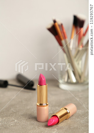 Set of make-up products on grey background. Vertical photo Set of make-up products on grey background. Vertical photo 119293767