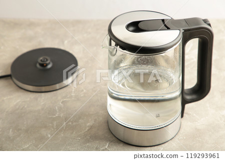 Glass electric kettle with water on grey background. 119293961