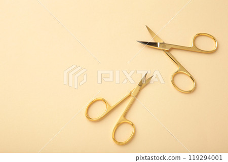 Scissors for manicure woman nails on beige background with copy space 119294001