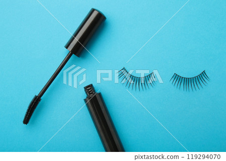 Black eyelashes and mascara on blue background 119294070