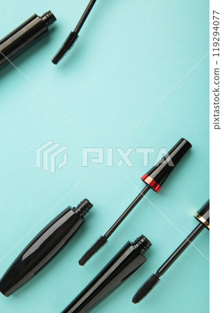 Black mascara wand and tube on mint background with copy space. Vertical photo 119294077