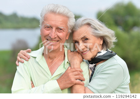 Portrait of beautiful senior couple posing in the park Portrait of beautiful senior couple posing in the park 119294142