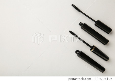 Black mascara wand and tube on grey background with copy space 119294196