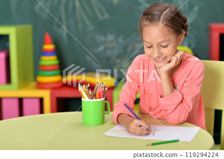 Portrait of cute little girl drawing at home 119294224