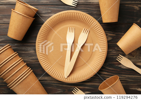 Eco friendly disposable tableware on a brown background 119294276