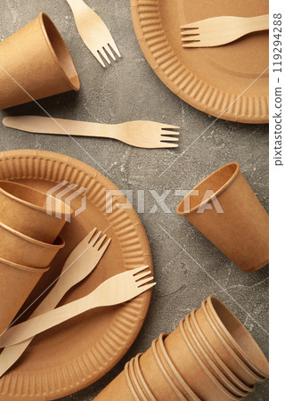 Eco friendly disposable tableware on a grey background. Vertical photo Eco friendly disposable tableware on a grey background. Vertical photo 119294288