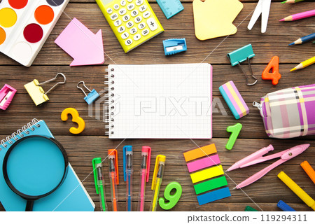 School supplies with notebook on grey wooden background. Back to school. Flat lay. School supplies with notebook on grey wooden background. Back to school. Flat lay. 119294311