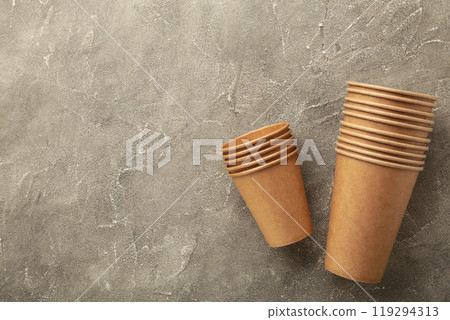Disposable paper cups on blue background with copy space. Coffee concept. 119294313