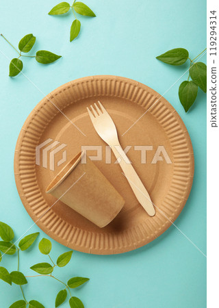 Eco friendly disposable dishes with green leaves on blue background. Zero waste, eco friendly, plastic free background. Vertical photo Eco friendly disposable dishes with green leaves on blue background. Zero waste, eco friendly, plastic free background. Vertical photo 119294314