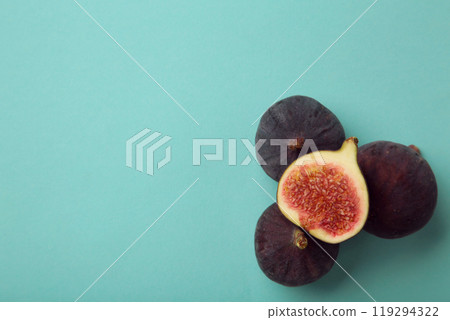 Fresh ripe figs on blue background. Tropical fruit Fresh ripe figs on blue background. Tropical fruit 119294322