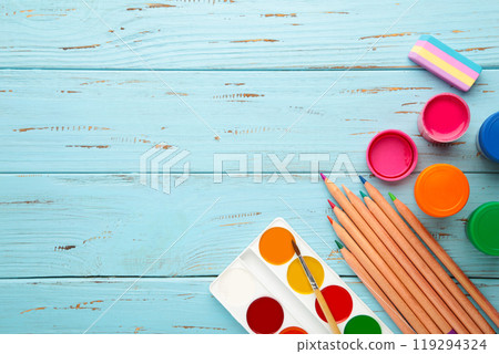 School supplies on blue wooden background with copy space. Back to school concept. School supplies on blue wooden background with copy space. Back to school concept. 119294324