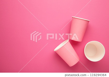 Disposable paper cups on pink background. Top view. 119294364