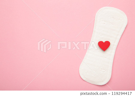 Menstrual pads on pink background. Menstruation cycle. Hygiene and protection. A heart on a menstrual pad. 119294417
