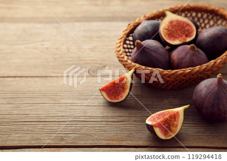 Group of figs in a bowl on grey wooden background. Group of figs in a bowl on grey wooden background. 119294418