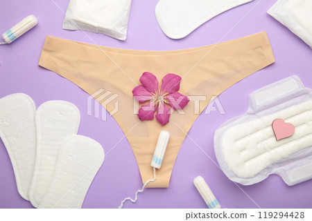 Women's panties with menstrual pads and tampons on pastel purple background. Top view. Concept of critical days, menstruation, feminine hygiene 119294428