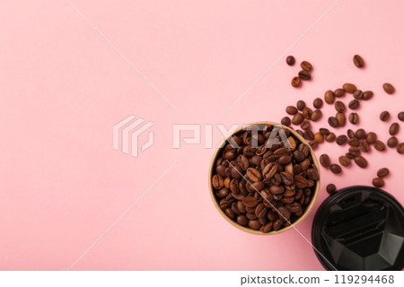 Coffee beans and paper coffee cup on pink background. 119294468