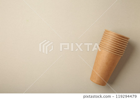 Disposable paper cups on grey background. Coffee concept. Disposable paper cups on grey background. Coffee concept. 119294479