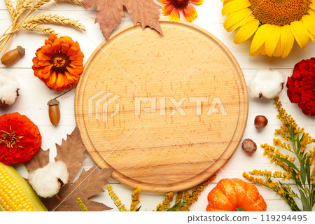 Autumn composition. Frame made of fresh flowers on white wooden background. Flat lay, top view, copy space. Thanksgiving day 119294495
