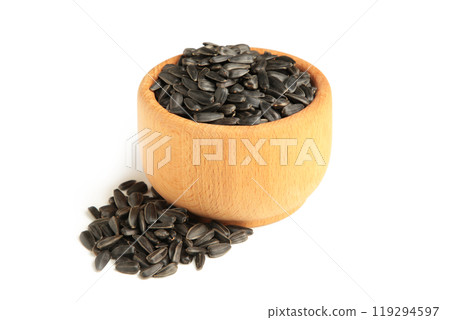 Sunflower seeds in wooden bowl isolated on white background. 119294597