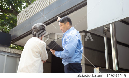 Man in work clothes and senior woman inspecting Man in work clothes and senior woman inspecting 119294649