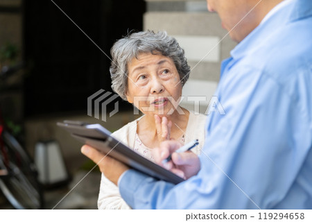 Man in work clothes and senior woman inspecting Man in work clothes and senior woman inspecting 119294658