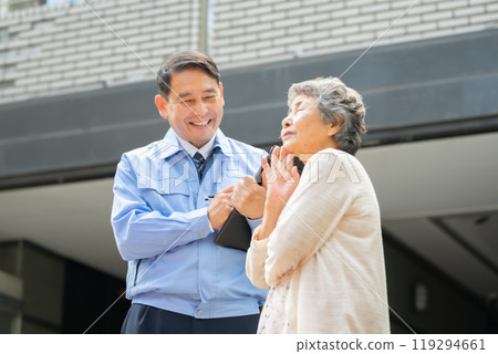 Man in work clothes and senior woman inspecting Man in work clothes and senior woman inspecting 119294661