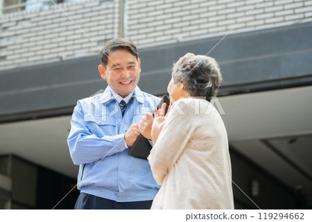 Man in work clothes and senior woman inspecting Man in work clothes and senior woman inspecting 119294662