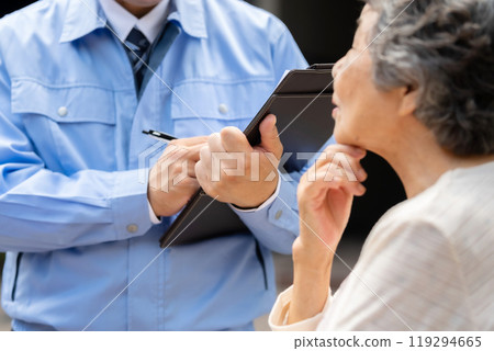 Man in work clothes and senior woman inspecting 119294665