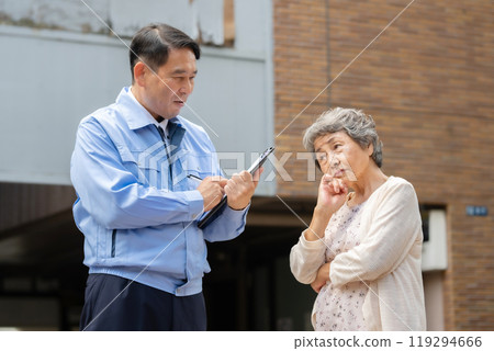 Man in work clothes and senior woman inspecting 119294666