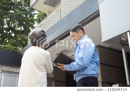 Man in work clothes and senior woman inspecting 119294714