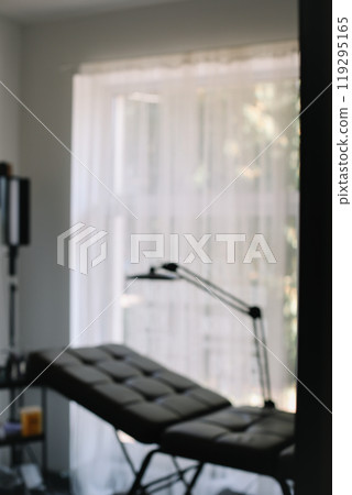 equipment in a modern cosmetology clinic. Lamp and comfortable Chair in a beauty salon equipment in a modern cosmetology clinic. Lamp and comfortable Chair in a beauty salon 119295165