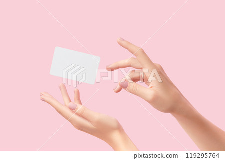 Womans hand touch a white blank business card that floats on a pink background. Flat lay of a simple business card with top view 119295764