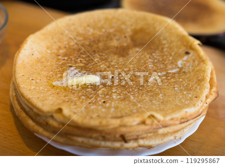 stack of appetizing flour pancakes in the kitchen during cooking 119295867