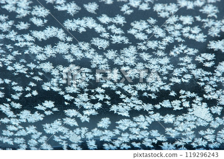 Frost crystals on a thin ice pond on a cold sub-zero morning 2 119296243