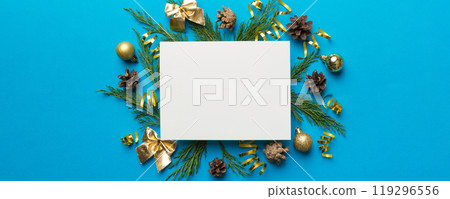 Flat lay Christmas composition. square Paper blank, pine tree branches, christmas decorations on Colored background. Top view, copy space for text Flat lay Christmas composition. square Paper blank, pine tree branches, christmas decorations on Colored background. Top view, copy space for text 119296556