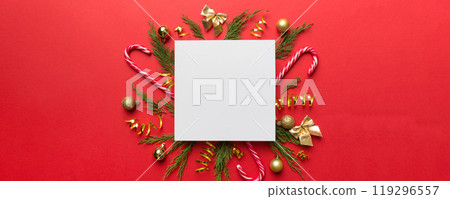 Flat lay Christmas composition. square Paper blank, pine tree branches, christmas decorations on Colored background. Top view, copy space for text Flat lay Christmas composition. square Paper blank, pine tree branches, christmas decorations on Colored background. Top view, copy space for text 119296557