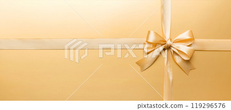 Top view of gold ribbon rolled and yellow bow isolated on colored background. Flat lay with copy space 119296576