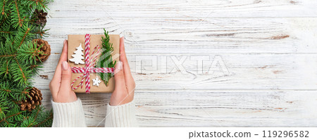 Christmas gift box wrapped in recycled paper, with ribbon bow, with ribbon on rustic background. Holiday concept 119296582