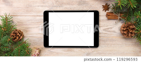 Digital tablet mock up with rustic Christmas wood background decorations for app presentation. top view with copy space Digital tablet mock up with rustic Christmas wood background decorations for app presentation. top view with copy space 119296593